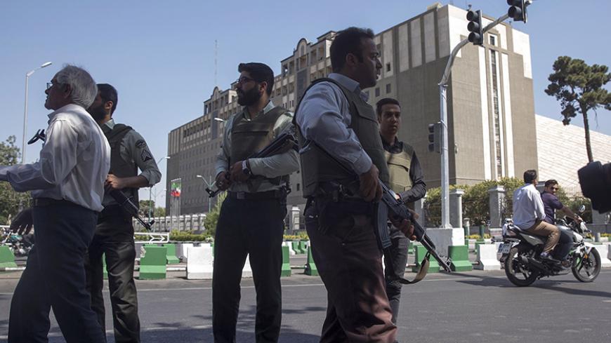 TEHRAN, IRAN - JUNE 7: Police officers stand outside Iran's parliament building following an attack by several gunmen on June 7, 2017 in Tehran, Iran. At least 12 people were killed and dozens more wounded during simultaneous gun and suicide bomb attacks in Iran's capital.  A suicide bomber targeted the shrine of Ayatollah Ruhollah Khomeini while several gunmen launched an attack on the parliament building, which is now reportedly over following hours of audible gun-fire. (Photo by Majid Saeedi/Getty Images