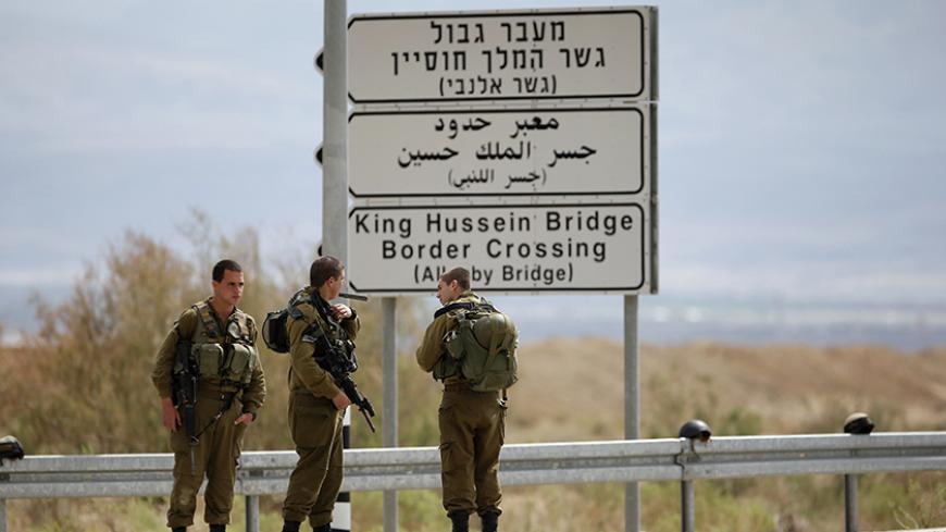 Israeli soldiers stand guard near the entrance to Allenby Bridge, a crossing point between Jordan and the occupied West Bank, near the West Bank town of Jericho March 10, 2014. Israeli soldiers shot and killed a Palestinian on Monday at the crossing point, Israeli and Palestinian security officials said. The Israeli military said the man had tried to seize a soldier's gun at the Allenby bridge, which spans the Jordan River, and that troops had then shot him. REUTERS/Ronen Zvulun (WEST BANK - Tags: POLITICS 