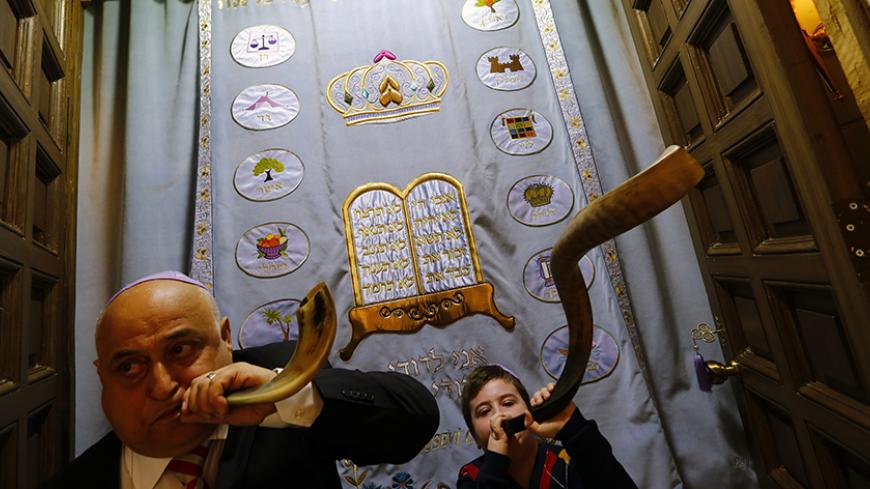 Istanbul Jewish community members Eftali Pinto (L) and Aviel Kohen (9), use shofars, musical instruments made from the horn of a ram or other kosher animal, during the re-opening ceremony of the Great Synagogue in Edirne, western Turkey March 26, 2015. A five-year, $2.5 million government project has restored the Great Synagogue in the border city of Edirne, the first temple to open in Turkey in two generations. The opening is part of a relaxation of curbs on religious minorities during President Tayyip Erd