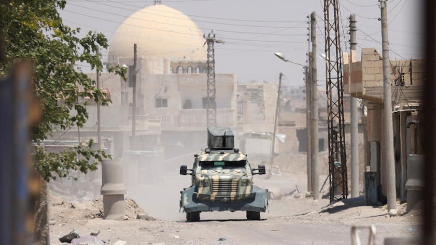 A military vehicle of SDF in west of Raqqa province,Syria June 18, 2017.REUTERS/ Rodi Said - RTS17L2S