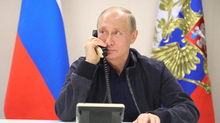 Russian President Vladimir Putin speaks over the phone with Turkish President Tayyip Erdogan while he inspects the work on the Turkish Stream gas pipeline project aboard the Pioneering Spirit pipeline-laying ship in the Black Sea near Anapa, Russia, June 23, 2017. Sputnik/Mikhail Klimentyev/Kremlin via REUTERS ATTENTION EDITORS - THIS IMAGE WAS PROVIDED BY A THIRD PARTY. - RTS18CTC