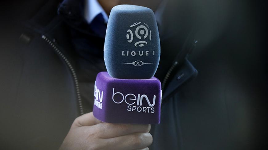 The logo of French TV channel 'beIN Sports' is seen on a microphone used by a TV journalist prior to a French league one soccer match at the Parc des Princes Stadium in Paris, March 5, 2016. REUTERS/Christian Hartmann  - RTS9MY4