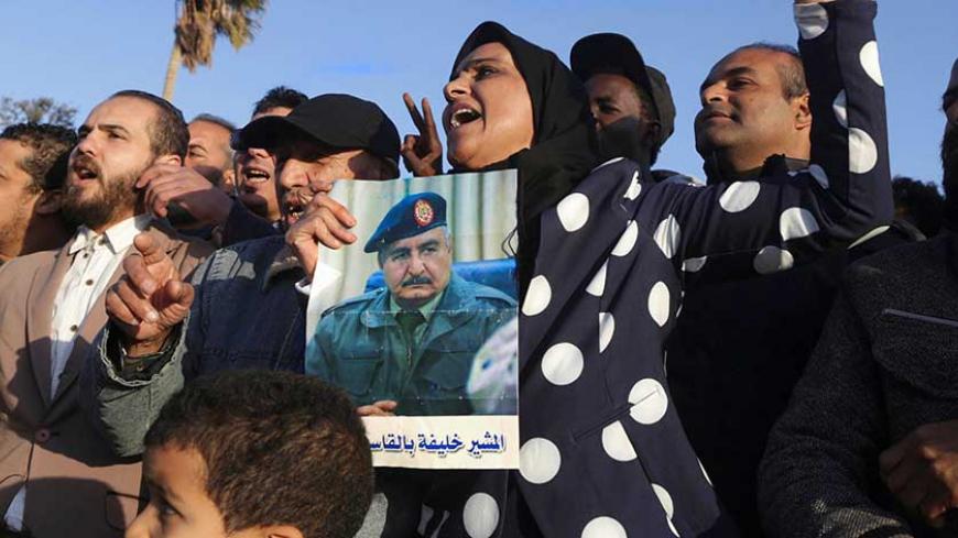 A demonstrator holds a picture of Eastern Libyan military commander Khalifa Haftar during a protest against the Italian government, which according to the protest organizers, supports the Bonyan Marsous forces that are mainly fighters from the city of Misrata, in Benghazi, Libya, February 12, 2017. REUTERS/Esam Omran Al-Fetori - RTSYBAT