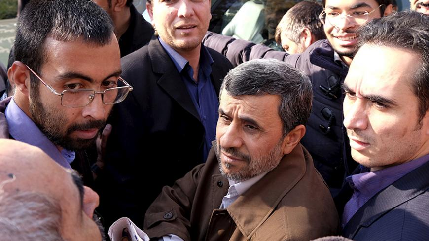 Former Iranian President Mahmoud Ahmadinejad (C front) listens to his supporters during the funeral ceremony of Iran's Ambassador to Lebanon Ghazanfar Roknabadi, who was killed in Saudi Arabia in a stampede at the haj pilgrimage, after Friday prayer in Tehran November 27, 2015. REUTERS/Raheb Homavandi/TIMA  ATTENTION EDITORS - THIS IMAGE WAS PROVIDED BY A THIRD PARTY. FOR EDITORIAL USE ONLY.  - RTX1W3E5