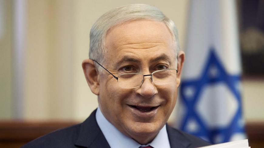 Israeli Prime Minister Benjamin Netanyahu smiles the weekly cabinet meeting in Jerusalem January 17, 2016. REUTERS/Dan Balilty/Pool  - RTX22Q2N
