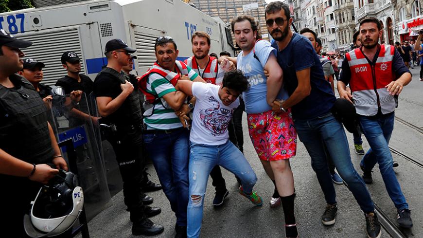 Plainclothes police officers detain LGBT rights activists as they try to gather for a pride parade, which was banned by the governorship, in Istanbul, Turkey, June 26, 2016. REUTERS/Murad Sezer TPX IMAGES OF THE DAY - RTX2IB9Y