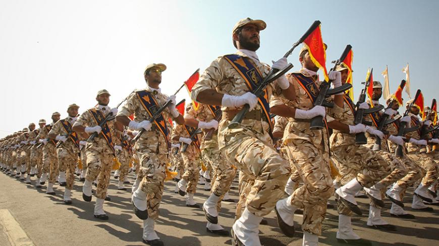 Members of the Iranian revolutionary guard march during a parade to commemorate the anniversary of the Iran-Iraq war (1980-88), in Tehran September 22, 2011. REUTERS/Stringer/File Photo - RTX2O26E