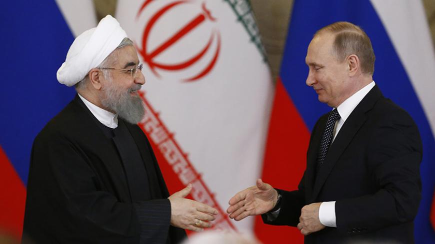 Russian President Vladimir Putin shakes hands with Iranian President Hassan Rouhani during a joint news conference following their meeting at the Kremlin in Moscow, Russia March 28, 2017. REUTERS/Sergei Karpukhin - RTX332WO