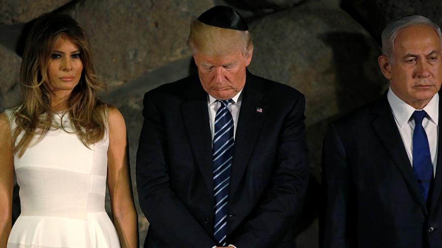 U.S. President Donald Trump and first lady Melania Trump (L) participate in a wreath-laying with Israel's Prime Minister Benjamin Netanyahu (R) at the Yad Vashem holocaust memorial in Jerusalem May 23, 2017. REUTERS/Jonathan Ernst - RTX3794Q
