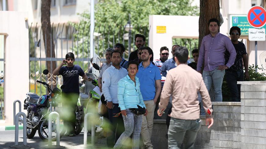 People gather near the parliament's building during a gunmen attack in central Tehran, Iran, June 7, 2017. TIMA via REUTERS ATTENTION EDITORS - THIS IMAGE WAS PROVIDED BY A THIRD PARTY. FOR EDITORIAL USE ONLY. - RTX39DR9