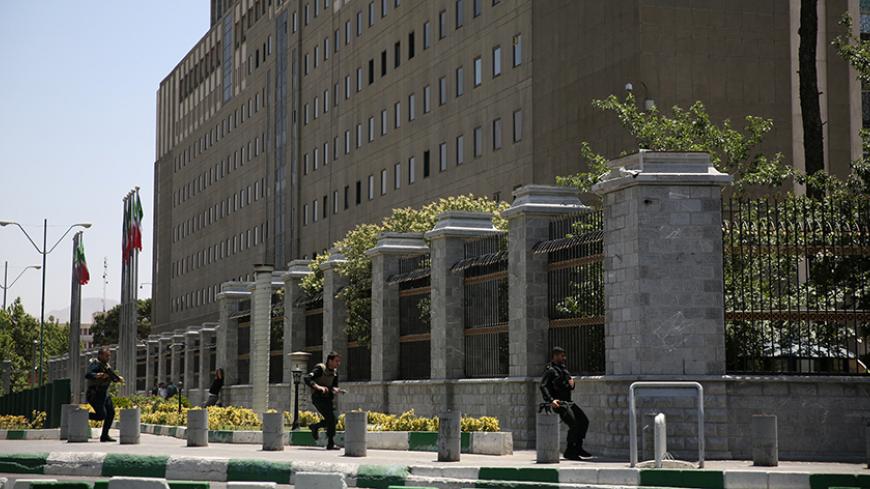 Members of Iranian forces run during a gunmen attack at the parliament's building in central Tehran, Iran, June 7, 2017. TIMA via REUTERS    ATTENTION EDITORS - THIS IMAGE WAS PROVIDED BY A THIRD PARTY. FOR EDITORIAL USE ONLY.          TPX IMAGES OF THE DAY - RTX39E45