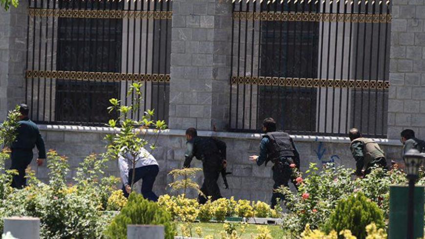 Members of Iranian forces run during an attack on the Iranian parliament in central Tehran, Iran, June 7, 2017. Omid Vahabzadeh/TIMA via REUTERS ATTENTION EDITORS - THIS IMAGE WAS PROVIDED BY A THIRD PARTY. FOR EDITORIAL USE ONLY. - RTX39EMX