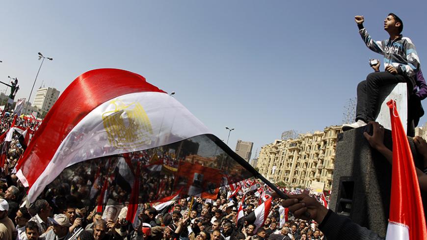 People wave Egyptian flags during a pro-democracy rally at Tahrir Square, in Cairo March 4, 2011. Egypt's new Prime Minister-designate Essam Sharaf told thousands of protesters in Tahrir Square on Friday that he would work to meet their demands and saluted the "martyrs" of the country's revolution. REUTERS/Peter Andrews (EGYPT - Tags: CIVIL UNREST POLITICS IMAGES OF THE DAY) - RTR2JFEF