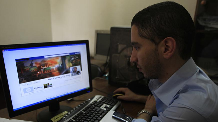 A Palestinian man looks at the Facebook page of Avichay Adraee, the spokesman of the Israeli Army to the Arabic media, after hackers replaced his cover photo with that of the Ezzedine al-Qassam Brigade during the "#Op_Israel" campaign launched by the activist group Anonymous, in Gaza City on April 7, 2013. The hackers reportedly hit several Israeli websites including that of the premier's office, the defence ministry, the education ministry and the Central Bureau of Statistics, among others, but all appeare