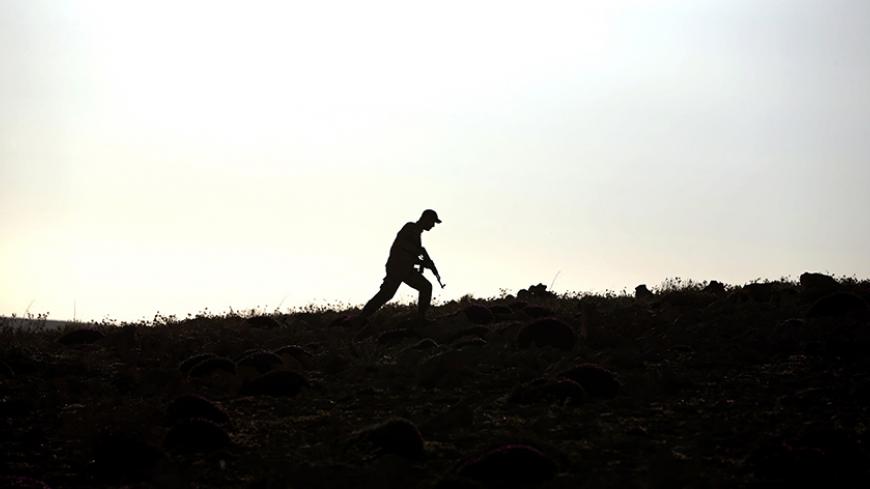 A Hezbollah fighter patrols a hill on the Lebanese side of the Qalamun mountains on the border with Syria on May 20, 2015. Ali Akbar Velayati, foreign affairs adviser to supreme leader Ayatollah Ali Khamenei, said on May 18 during a trip to Beirut, that Tehran was proud of its key ally Hezbollah for advances it has made against rebels in a Syrian region on the Lebanese border. AFP PHOTO / JOSEPH EID        (Photo credit should read JOSEPH EID/AFP/Getty Images)