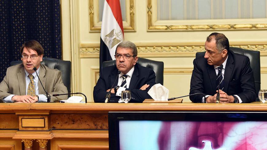 The International Monetary Fund head of delegation for Egypt, Chris Jarvis (L), Egypts Minister of Finance Amr al-Garhy (C) and Central Bank of Egypt chief Tarek AmeR (R) attend a joint press conference in Cairo on August 11, 2016. 
IMF has reached an initial agreement with Egypt for $12 billion in funding over three years, the fund said. The Egyptian government hopes the deal will provide a lifeline amid a dollar shortage, dwindling foreign reserves and an economy battered by years of unrest.

 / AFP / STR