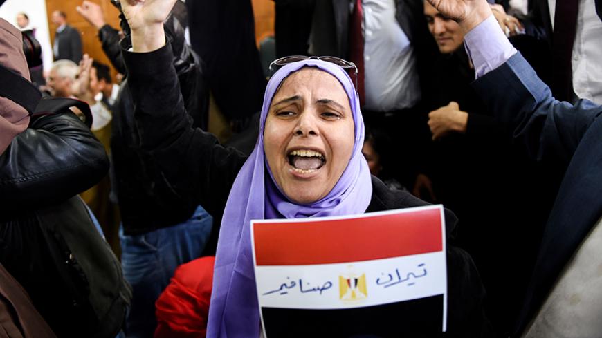 An Egyptian woman celebrates with a national flag defaced with the words "Tiran" and "Sanafir" after the High Administrative Court upheld on January 16, 2017 a ruling voiding a government agreement to hand over the two Red Sea islands of Tiran and Sanafir to Saudi Arabia in a deal that had sparked protests in Egypt. / AFP / MOHAMED EL-SHAHED        (Photo credit should read MOHAMED EL-SHAHED/AFP/Getty Images)