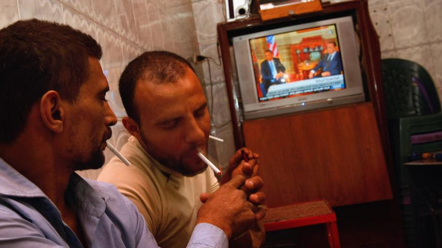 CAIRO, EGYPT - JUNE 4:  Egyptian men react with applause as they watch US President Barack Obama's key Middle East speech on TV in a coffee shop in the Islamic old city June 4, 2009 in Cairo, Egypt. In his speech, President Obama called for a "new beginning between the United States and Muslims", declaring that "this cycle of suspicion and discord must end".  (Photo by David Silverman/Getty Images)
