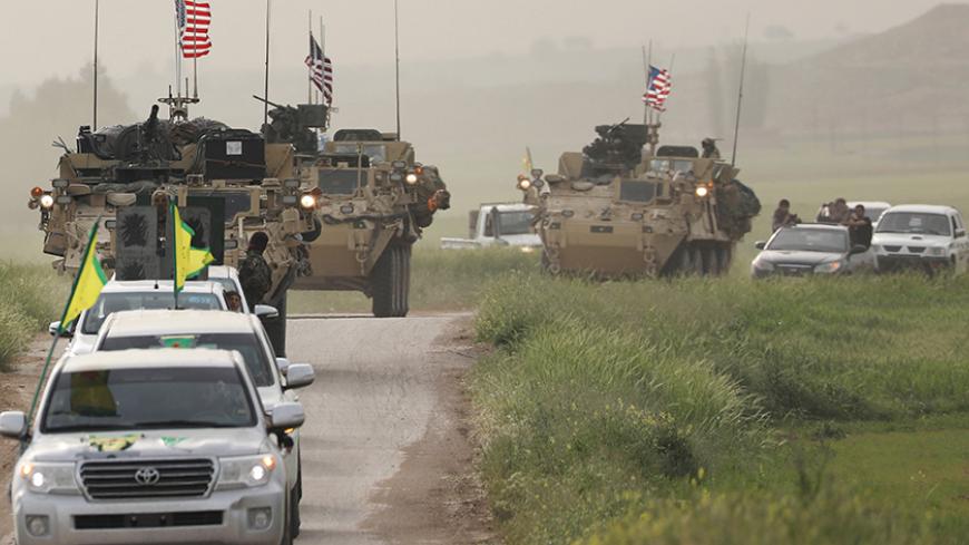 Kurdish fighters from the People's Protection Units (YPG) head a convoy of U.S military vehicles in the town of Darbasiya next to the Turkish border, Syria April 28, 2017. REUTERS/Rodi Said - RTS14EFY