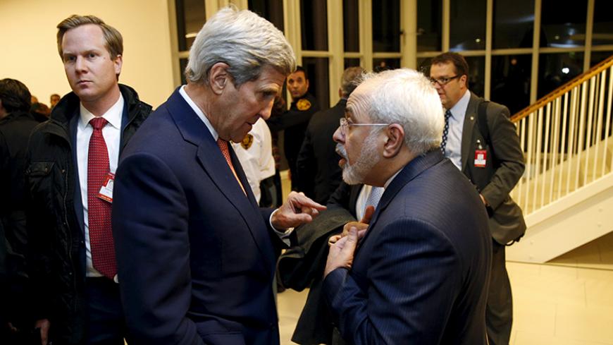 U.S. Secretary of State John Kerry talks with Iranian Foreign Minister Javad Zarif after the International Atomic Energy Agency (IAEA) verified that Iran has met all conditions under the nuclear deal, in Vienna January 16, 2016. REUTERS/Kevin Lamarque - RTX22P9I