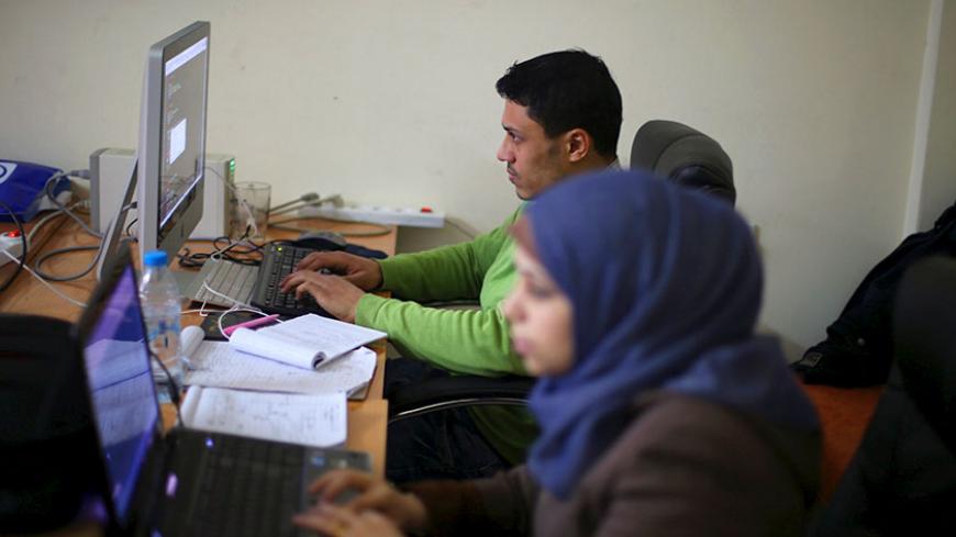 Young Palestinian entrepreneurs use their computers at Gaza Sky Geeks office, in Gaza City January 18, 2016. Picture taken January 18, 2016. REUTERS/Ibraheem Abu Mustafa  - RTX242SL