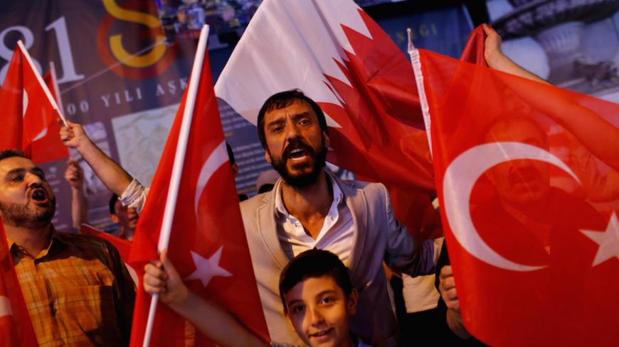 People shout slogans as they hold Turkish and Qatari flags during a demonstration in favour of Qatar in central Istanbul, Turkey, late June 7, 2017. REUTERS/Murad Sezer - RTX39JA6