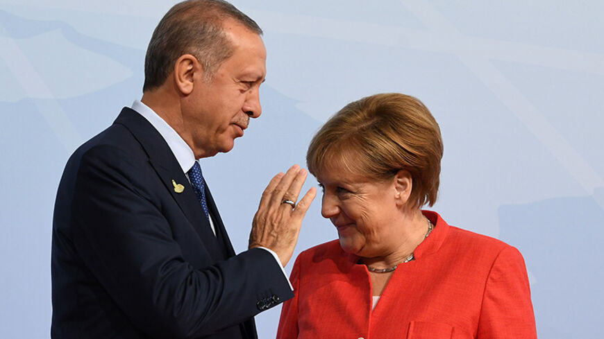 German Chancellor Angela Merkel greets Turkey's President Recep Tayyip Erdogan at the beginning of the G20 summit in Hamburg, Germany, July 7, 2017. REUTERS/Bernd Von Jutrczenka/POOL - RTX3AG1I