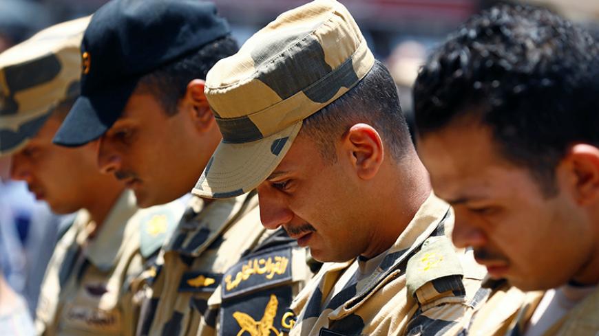 Egyptian army officers react during the funeral of officer Khaled al-Maghrabi, who was killed during a suicide bomb attack on an army checkpoint in Sinai, in his hometown Toukh, Al Qalyubia Governorate, north of Cairo, Egypt 8 July, 2017. REUTERS/Mohamed Abd El Ghany - RTX3AMGR