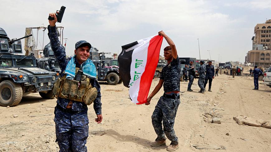 Iraqi Federal Police celebrate in the Old City of Mosul, Iraq July 8, 2017. REUTERS/Ahmed Saad - RTX3AMLG