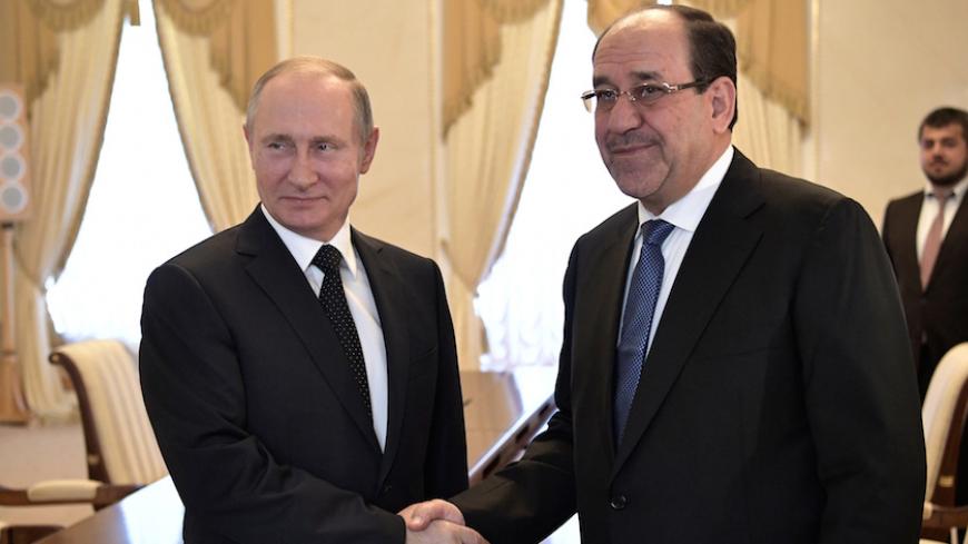 Russian President Vladimir Putin shakes hands with Iraqi Vice President Nuri al-Maliki during their meeting in St. Petersburg, Russia, July 25, 2017. Sputnik/Alexei Nikolsky/Kremlin via REUTERS ATTENTION EDITORS - THIS IMAGE WAS PROVIDED BY A THIRD PARTY. - RTX3CTS4