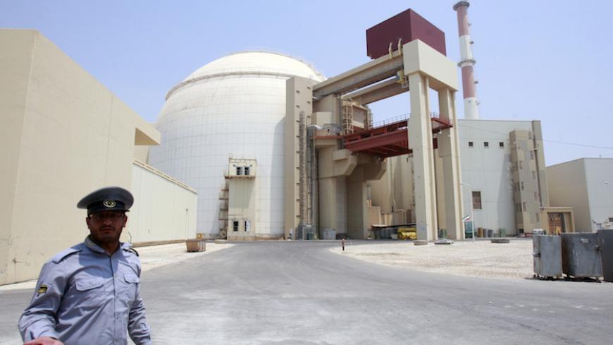 EDITORS' NOTE: Reuters and other foreign media are subject to Iranian restrictions on leaving the office to report, film or take pictures in Tehran.

A security official talks to journalists in front of Bushehr main nuclear reactor, 1,200 km (746 miles) south of Tehran, August 21, 2010. Iran began fuelling its first nuclear power plant on Saturday, a potent symbol of its growing regional sway and rejection of international sanctions designed to prevent it building a nuclear bomb.  REUTERS/Raheb Homavandi 