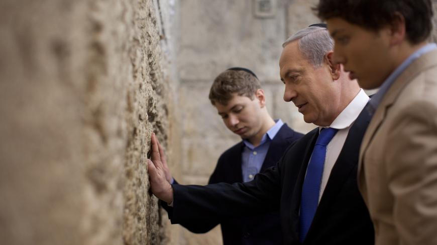 JERUSALEM, ISRAEL - JANUARY 22:  Israeli Prime Minister Benjamin Netanyahu prays with his sons Yair and Avner at the Western Wall, Judaism holiest site on January 22, 2013 in Jerusalem, Israel. Israel's general election voting has begun today as polls show Netanyahu is expected to return to office with a narrow majority.  (Photo by Uriel Sinai/Getty Images)