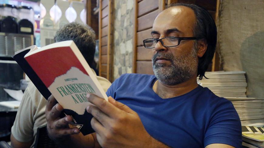 Iraqi writer, Ahmed Saadawi poses with his book titled in French "Frankenstein a Bagdad" (Frankenstein in Baghdad) on August 4, 2016 in the capital Baghdad.
When Ahmed Saadawi finished writing "Frankenstein in Baghdad", a dark fantasy about the war that tore Iraq apart a decade ago, he thought his novel dealt with the past. But just like the monster Mary Shelley first dreamt up exactly 200 years ago, Saadawi's hero took on a life of its own. Saadawi won the International Prize for Arabic Fiction in 2014 and