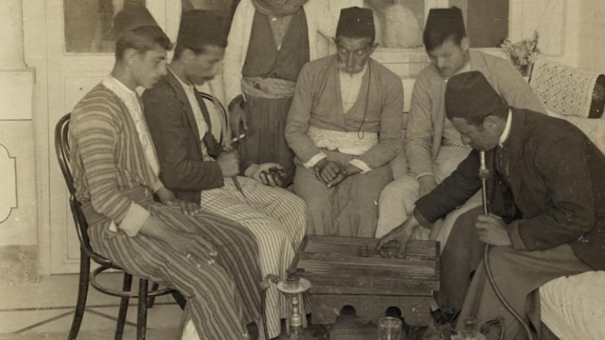 UNSPECIFIED - CIRCA 1903:  Turkish residents of Nazareth playing checkers and smoking narghiles  (Photo by Buyenlarge/Getty Images)