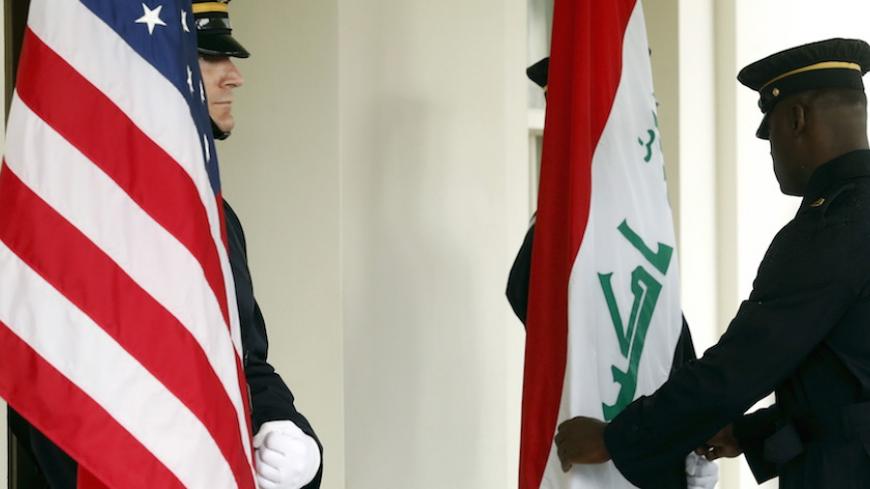Military honor guards dress an Iraqi flag as they prepare to greet Iraq's Prime Minister Haider Al-Abadi upon his arrival to meet with U.S. President Barack Obama at the White House in Washington April 14, 2015. Al-Abadi and Obama will discuss the fight against Islamic State on Tuesday at a White House meeting likely to be dominated by Iraqi requests for U.S. arms and tension over Iran's role on the battlefield.  REUTERS/Jonathan Ernst - RTR4XARN