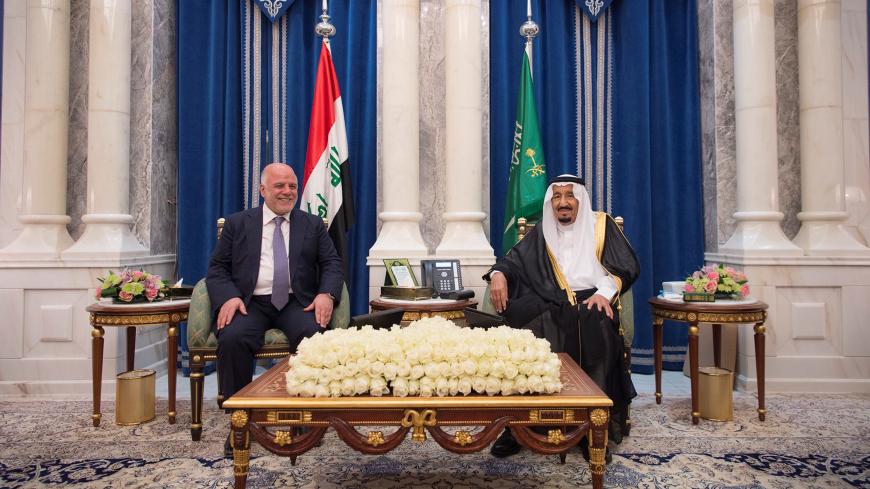 Saudi Arabia's King Salman bin Abdulaziz Al Saud (R) talks with Iraqi Prime Minister Haider al-Abadi in Jeddah, Saudi Arabia, June 19, 2017. Bandar Algaloud/Courtesy of Saudi Royal Court/Handout via REUTERS ATTENTION EDITORS - THIS PICTURE WAS PROVIDED BY A THIRD PARTY. - RTS17RSB