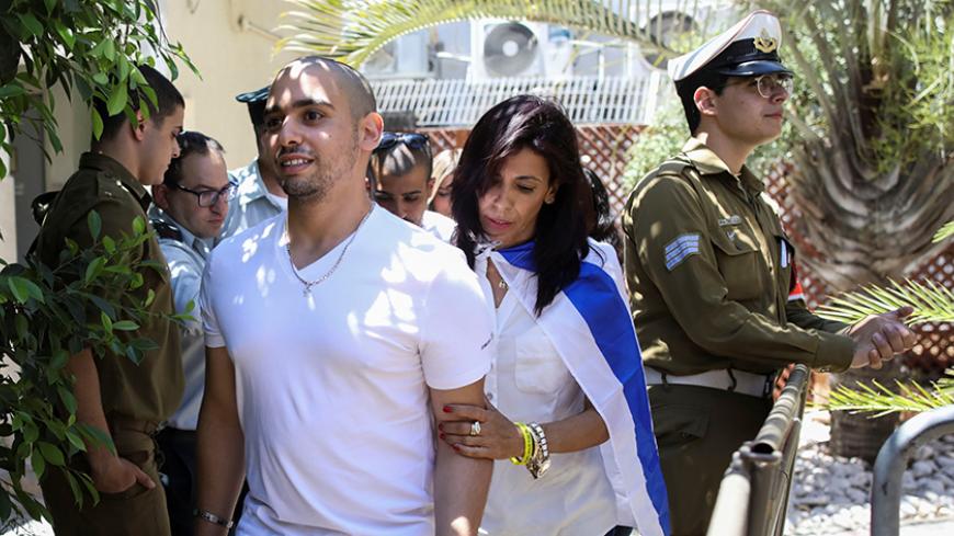 Mother of former Israeli soldier Elor Azaria, who was convicted of manslaughter and sentenced to 18 months imprisonment for killing a wounded and incapacitated Palestinian assailant, arrives together with her son to hear the ruling at an Israeli military appeals court in Tel Aviv, Israel July 30, 2017. REUTERS/Dan Balilty/Pool - RTS19QJ1