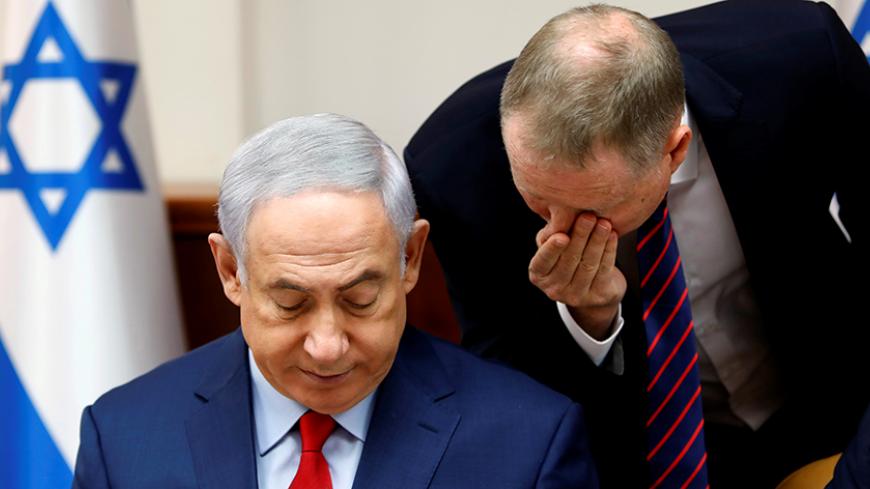 Israeli Prime Minister Benjamin Netanyahu listens to an advisor at the start of the weekly cabinet meeting at his office in Jerusalem August 6, 2017. REUTERS/Gali Tibbon/Pool - RTS1AKYO