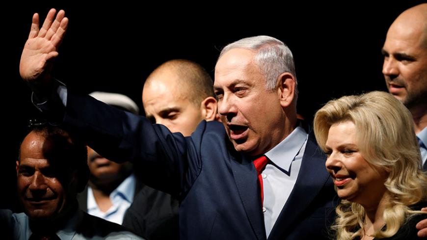 Israeli Prime minister Benjamin Netanyahu (C) and his wife Sara react to his supporters during an event by his Likud Party, in Tel Aviv, Israel August 9, 2017. REUTERS/Amir Cohen - RTS1B3H9
