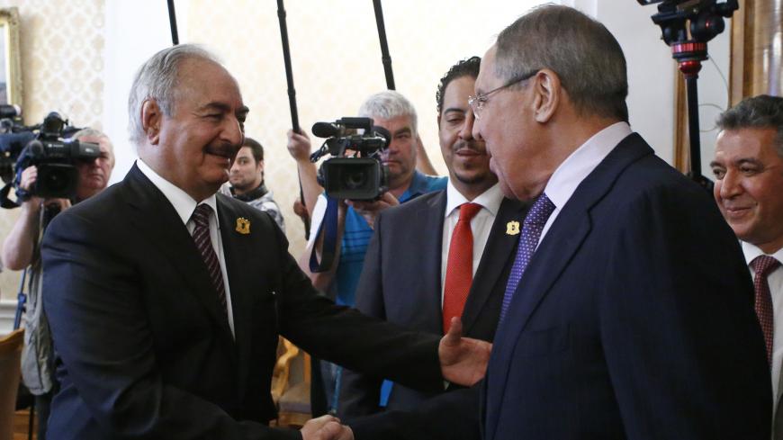 General Khalifa Haftar (L), commander in the Libyan National Army (LNA), shakes hands with Russian Foreign Minister Sergei Lavrov during a meeting in Moscow, Russia August 14, 2017. REUTERS/Sergei Karpukhin - RTS1BPIW