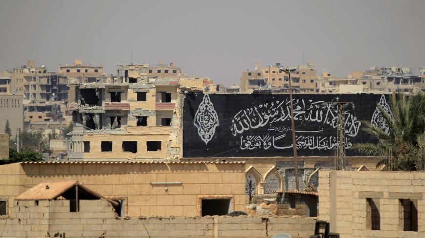 A banner belonging to Islamic States fighters is seen during a battle with member of the Syrian Democratic Forces in Raqqa, Syria August 16, 2017. REUTERS/Zohra Bensemra - RTS1C16D