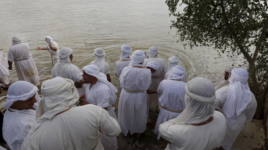 Mandaeans perform religious rituals during the Benja festival along the Tigris river in Baghdad March 16, 2016. REUTERS/Ahmed Saad - RTSAP9A