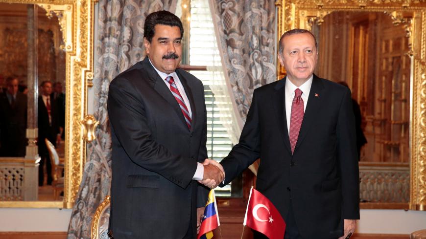 Venezuela's President Nicolas Maduro (L) shakes hands with Turkish President Tayyip Erdogan during a meeting in Istanbul, Turkey October 10, 2016. Miraflores Palace/Handout via REUTERS ATTENTION EDITORS - THIS PICTURE WAS PROVIDED BY A THIRD PARTY. EDITORIAL USE ONLY. - RTSRMVB