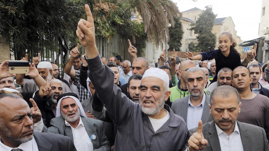 Leader of the northern Islamic Movement Sheikh Raed Salah gestures after leaving the district court in Jerusalem October 27, 2015. The Arab Israeli Muslim leader, seen by Israel as a powerful voice stoking Palestinian anger over a Jerusalem holy site, was ordered jailed for 11 months on Tuesday for comments he made in 2007. Sheik Raed Salah, leader of the Islamic Movement's northern section was convicted for incitement to violence in 2013, the Justice Ministry said, charges he denied. His attorney said he w