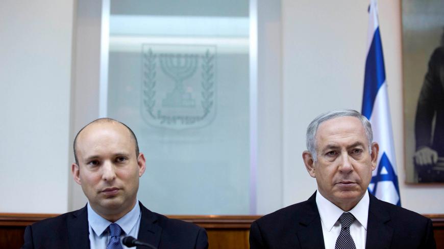 Israeli Prime Minister Benjamin Netanyahu (R) sits next to Education Minister Naftali Bennett during the weekly cabinet meeting at his office in Jerusalem, 30 August  2016. REUTERS/Abir Sultan/Pool - RTX2NKHK