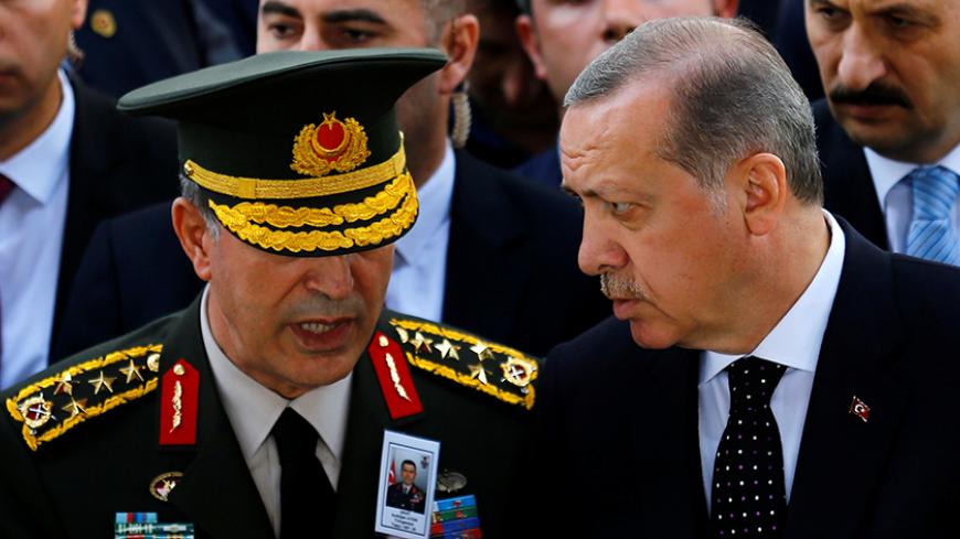 Turkish President Tayyip Erdogan and Chief of Staff General Hulusi Akar chat as they attend the funeral of Major General Aydogan Aydin who was killed in a helicopter crash in Sirnak, on Wednesday, at Ahmet Hamdi Akseki Mosque in Ankara, Turkey, June 1, 2017. REUTERS/Umit Bektas TPX IMAGES OF THE DAY - RTX38KLG