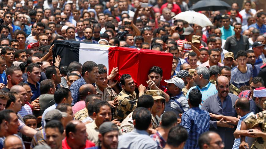 Egyptian relatives and friends carry the coffin of the officer Khaled al-Maghrabi, who was killed during a suicide bomb attack on an army checkpoint in Sinai, during his funeral in his hometown Toukh, Al Qalyubia Governorate, north of Cairo, Egypt 8 July, 2017. REUTERS/Mohamed Abd El Ghany - RTX3AMDS