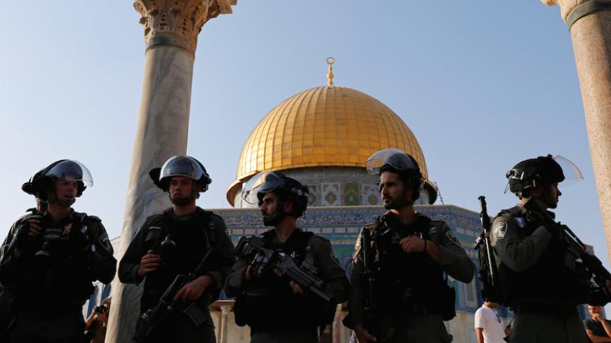 Israeli security forces stand at the compound known to Muslims as Noble Sanctuary and to Jews as Temple Mount, after Israel removed all security measures it had installed at the compound, and Palestinians entered the compound in Jerusalem's Old City July 27, 2017. REUTERS/Muammar Awad - RTX3D5M4