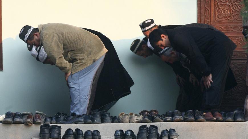 Men pray during Kurban-Ait, also known as Eid al-Adha in Arabic, at a mosque in the village of Nurabad, some 40 km (25 miles) west of the capital Dushanbe, November 16, 2010. Muslims around the world celebrate Eid al-Adha, marking the end of the haj, by slaughtering sheep, goats, cows and camels to commemorate Prophet Abraham's willingness to sacrifice his son Ismail on God's command.  REUTERS/Nozim Kalandarov  (TAJIKISTAN - Tags: RELIGION) - RTXUOWO