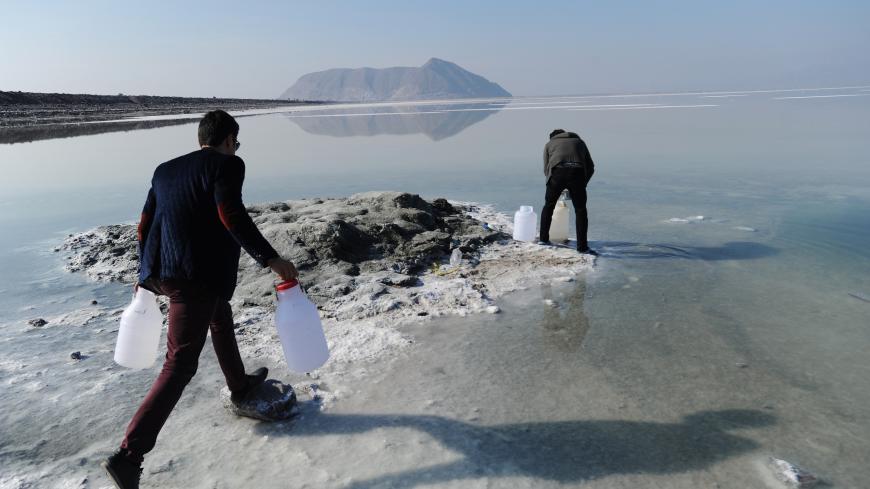 URMIEH, IRAN - JANUARY 23:  Iranian university student Vahid Rezaei (R) and his brother Saeed Rezaei collect water samples from the salt-encrusted former lakebed of Iran's shrinking Lake Urmieh, which presents a risk of salt storms and future health and environmental problems on January 23, 2015 in Urmieh, northwest Iran. Once one of the largest salt lakes in the world, it has lost 90 percent of its volume in the past decade and symbolizes the scale of the water crisis facing Iran today. Decades of overuse,
